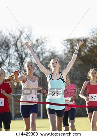 Runner crossing finish line in field View Large Photo Image Stock Image - Runner crossing finish line in field. Fotosearch