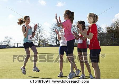 Runners cheering together in field View Large Photo Image Picture - Runners cheering together in field. Fotosearch