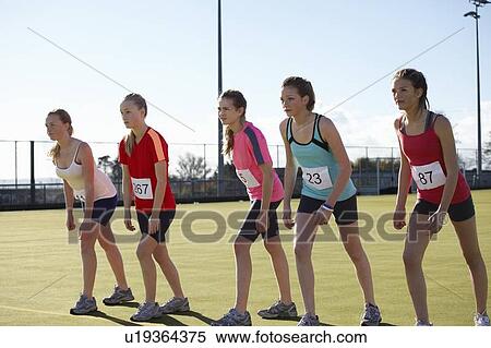 Runners lined up to race in field View Large Photo Image Stock Photography - Runners lined up to race in field. Fotosearch