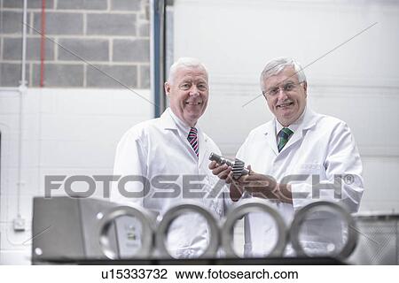 Stock Image - Scientists cleaning with ultrasonics. Fotosearch