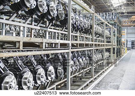 Stock Image - Shelves of axles in car factory. Fotosearch