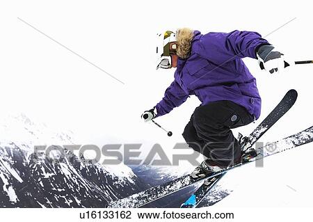 Skier jumping on snowy slope View Large Photo Image Stock Image - Skier jumping on snowy slope. Fotosearch