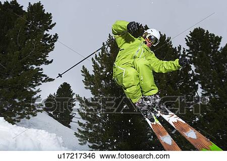Skier jumping on snowy slope View Large Photo Image Stock Photograph - Skier jumping on snowy slope. Fotosearch