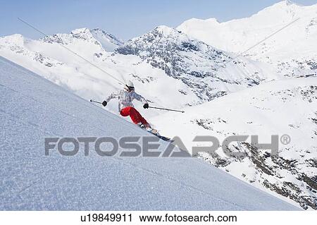 Stock Image - Skier on snowy slope. Fotosearch