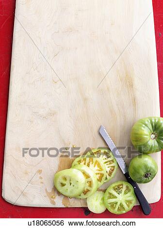 Stock Photograph - Sliced green tomatoes on board. Fotosearch
