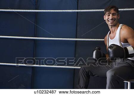 Smiling boxer sitting in ring View Large Photo Image Stock Photo - Smiling boxer sitting in ring. Fotosearch
