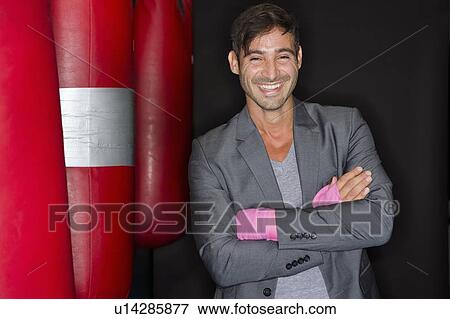 Stock Photo - Smiling boxer standing in gym. Fotosearch