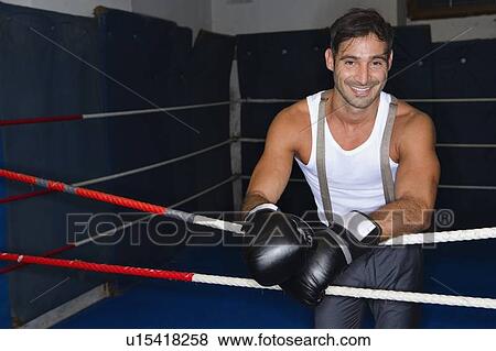 Smiling boxer standing in ring View Large Photo Image Stock Photo - Smiling boxer standing in ring. Fotosearch