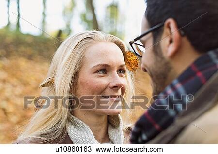 Smiling couple standing in forest View Large Photo Image Stock Image - Smiling couple standing in forest. Fotosearch