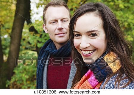 Smiling couple walking in forest View Large Photo Image Stock Photograph - Smiling couple walking in forest. Fotosearch