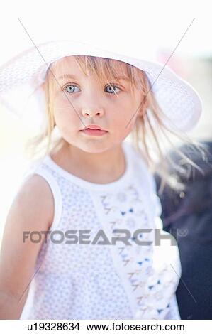 Picture - Smiling girl standing outdoors. Fotosearch