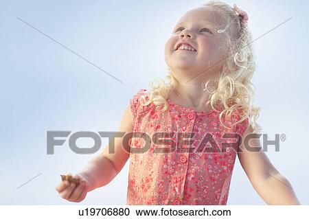 Smiling girl standing outdoors View Large Photo Image Stock Image - Smiling girl standing outdoors. Fotosearch