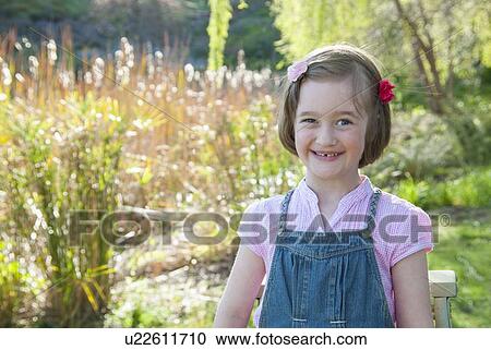 Smiling girl standing outdoors View Large Photo Image Stock Image - Smiling girl standing outdoors. Fotosearch