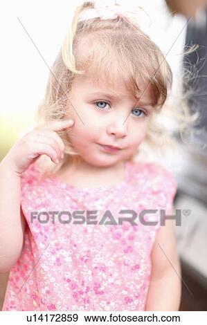 Stock Photo - Smiling girl standing outdoors. Fotosearch