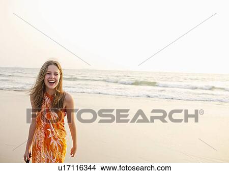 Smiling girl walking on beach View Large Photo Image Picture - Smiling girl walking on beach. Fotosearch
