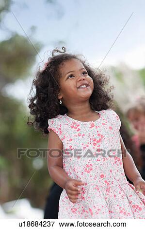 Stock Photo - Smiling girl walking outdoors. Fotosearch