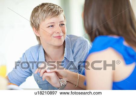 Smiling lesbian couple holding hands View Large Photo Image Stock Photo - Smiling lesbian couple holding hands. Fotosearch