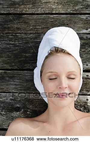 Smiling woman laying on wooden deck View Large Photo Image Stock Photo - Smiling woman laying on wooden deck. Fotosearch
