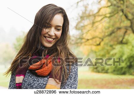 Smiling woman standing in forest View Large Photo Image Stock Photograph - Smiling woman standing in forest. Fotosearch
