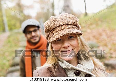Stock Image - Smiling woman standing outdoors. Fotosearch