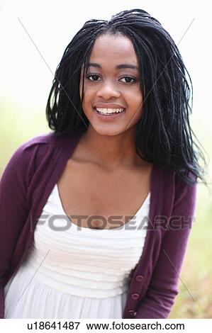 Stock Photo - Smiling woman standing outdoors. Fotosearch