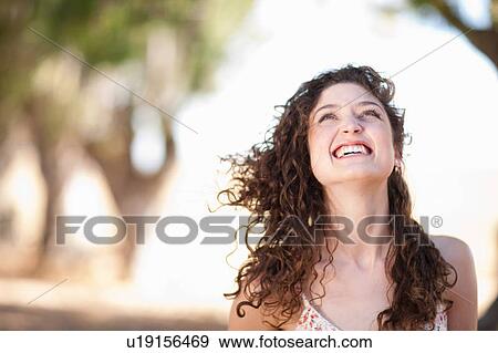 Smiling woman standing outdoors View Large Photo Image Stock Photo - Smiling woman standing outdoors. Fotosearch