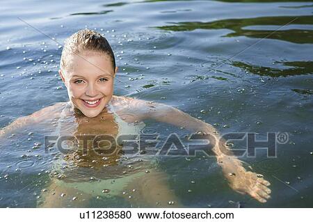 Smiling woman swimming in lake View Large Photo Image Stock Image - Smiling woman swimming in lake. Fotosearch