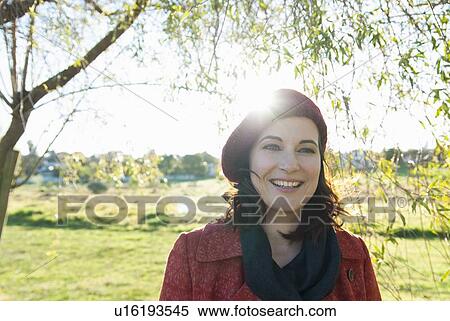Smiling woman walking in field View Large Photo Image Stock Photography - Smiling woman walking in field. Fotosearch