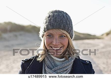 Smiling woman walking on beach View Large Photo Image Stock Photography - Smiling woman walking on beach. Fotosearch