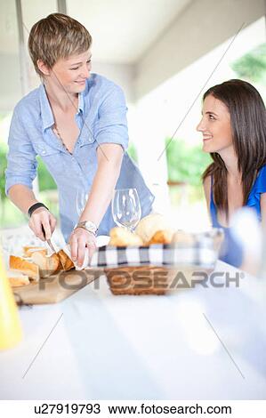 Smiling women having lunch together View Large Photo Image Stock Image - Smiling women having lunch together. Fotosearch