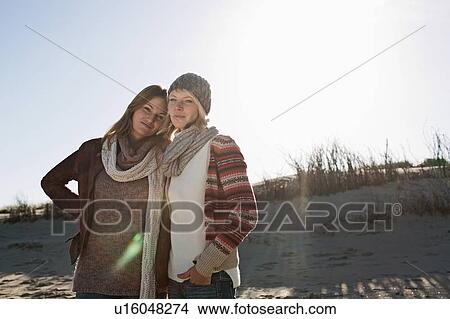 Smiling women hugging on beach View Large Photo Image Picture - Smiling women hugging on beach. Fotosearch