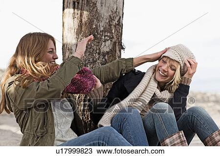 Smiling women playing on beach View Large Photo Image Stock Image - Smiling women playing on beach. Fotosearch
