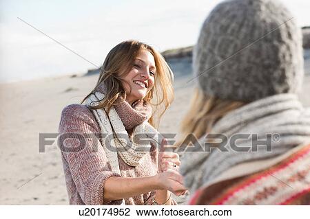Smiling women playing on beach View Large Photo Image Stock Image - Smiling women playing on beach. Fotosearch