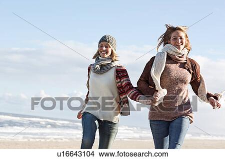 Smiling women running on beach View Large Photo Image Picture - Smiling women running on beach. Fotosearch