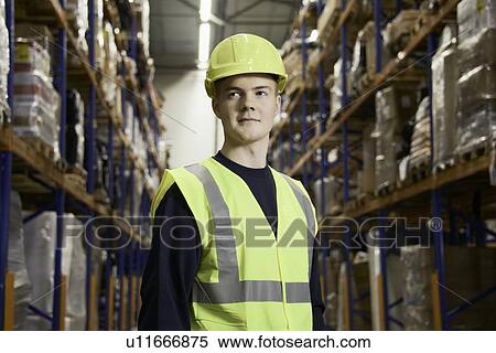 Smiling worker standing in warehouse View Large Photo Image Stock Photography - Smiling worker standing in warehouse. Fotosearch