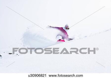 Stock Image - Snowboarder on snowy slope. Fotosearch
