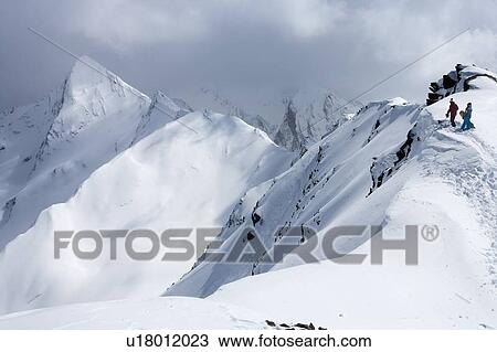 Snowboarders climbing snowy slope View Large Photo Image Stock Image - Snowboarders climbing snowy slope. Fotosearch