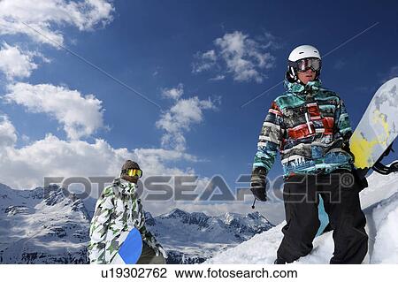 Snowboarders on snowy mountaintop View Large Photo Image Stock Image - Snowboarders on snowy mountaintop. Fotosearch