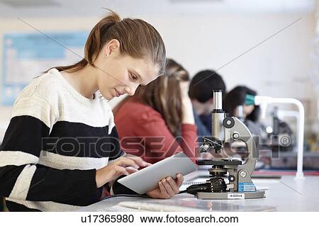 Stock Image - Student using tablet computer in class. Fotosearch