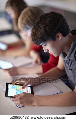 Student using tablet computer in class View Large Photo Image Stock Image - Student using tablet computer in class. Fotosearch