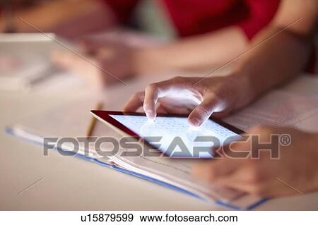 Student using tablet computer in class View Large Photo Image Stock Photo - Student using tablet computer in class. Fotosearch