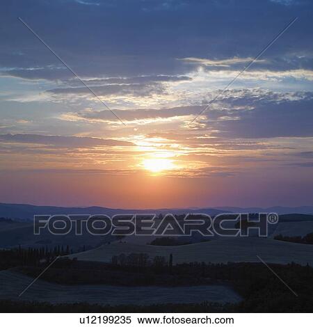 Stock Photography - Sun setting over rural landscape. Fotosearch