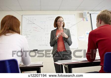 Teacher at whiteboard in science class View Large Photo Image Picture - Teacher at whiteboard in science class. Fotosearch