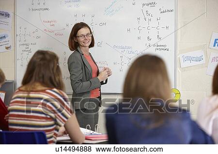 Stock Photo - Teacher at whiteboard in science class. Fotosearch