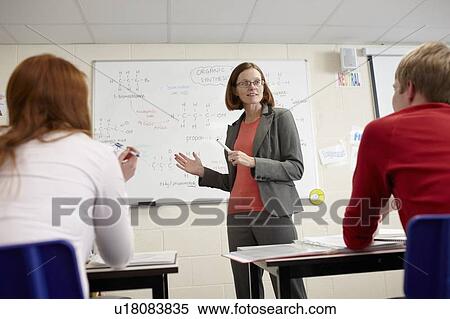 Teacher at whiteboard in science class View Large Photo Image Stock Photography - Teacher at whiteboard in science class. Fotosearch