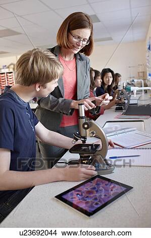 Teacher with student in science class View Large Photo Image Picture - Teacher with student in science class. Fotosearch