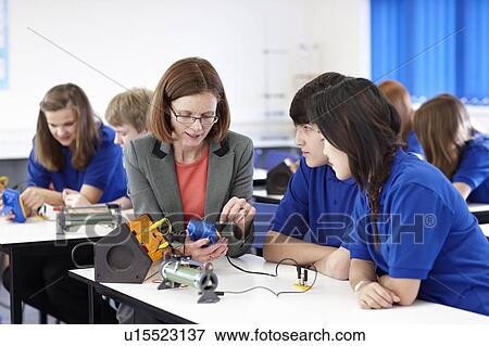 Teacher with students in science class View Large Photo Image Stock Photo - Teacher with students in science class. Fotosearch