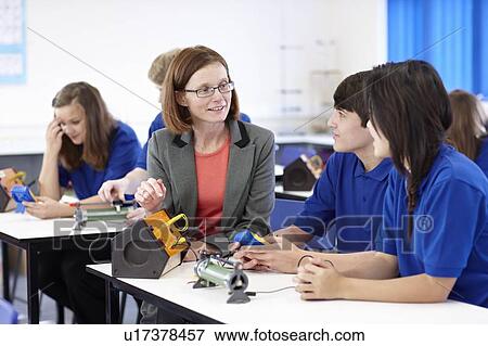 Stock Photo - Teacher with students in science class. Fotosearch