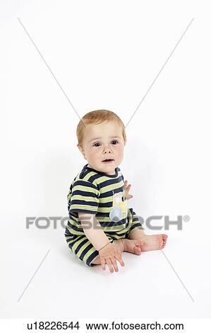 Toddler boy sitting on floor View Large Photo Image Picture - Toddler boy sitting on floor. Fotosearch