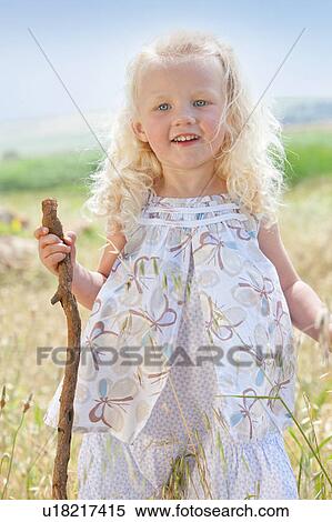 Toddler girl standing in tall grass View Large Photo Image Stock Photography - Toddler girl standing in tall grass. Fotosearch